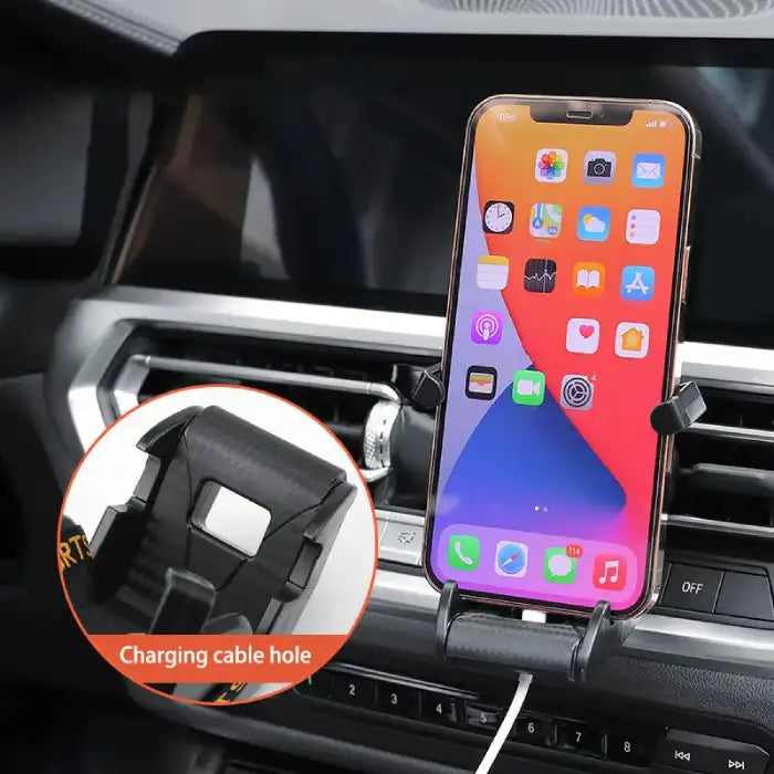 Car phone holder with iPhone docked and visible charging port access on vehicle air vent.