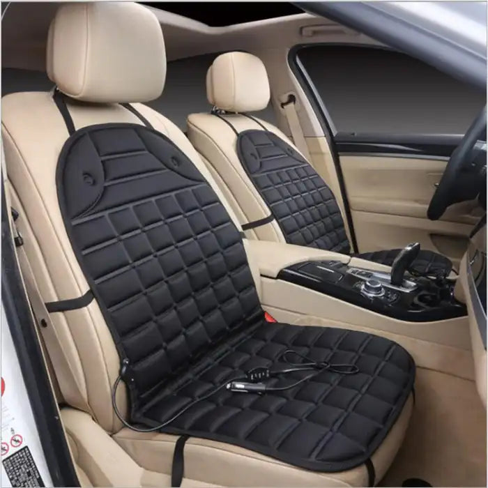 Car Seat Heater black padded cover on beige car seats with 12V plug attached.