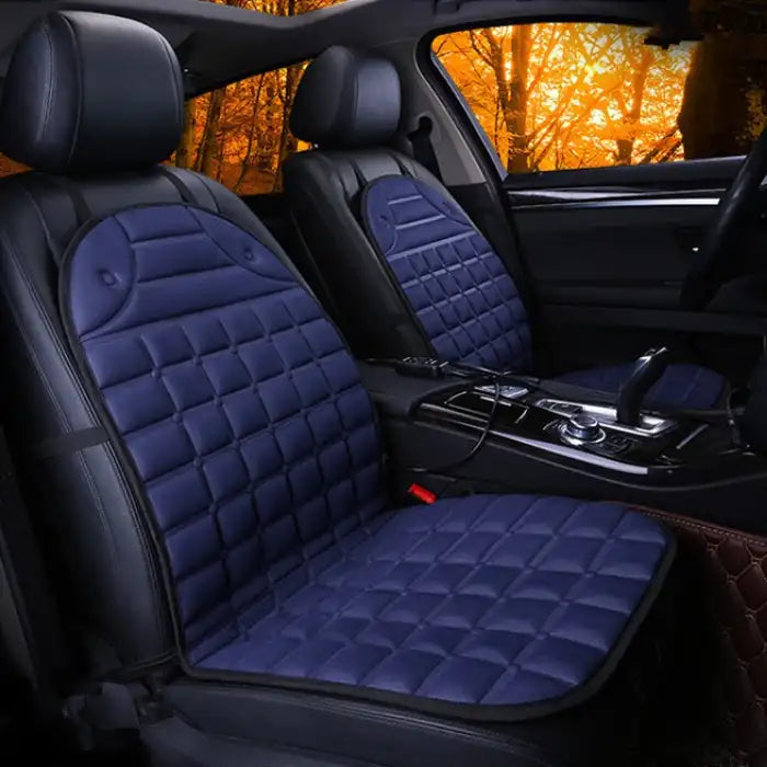 Car Seat Heater blue quilted pads installed on both front seats in black interior.