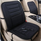 Car Seat Heater slim black cushion on beige car seat with 12V power cord.