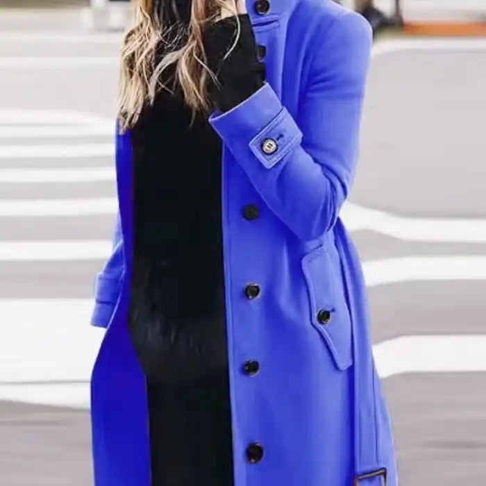 .Cardigan Large Coat in bright cobalt blue with black buttons styled on crosswalk with black innerwear.
