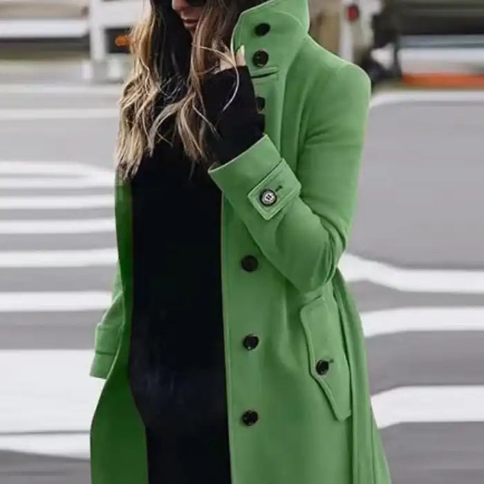 .Cardigan Large Coat in vibrant green styled outdoors, paired with black underlayer on street.