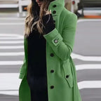 .Cardigan Large Coat in vibrant green styled outdoors, paired with black underlayer on street.
