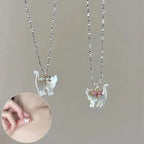 Cat Pendant Necklace worn on model, featuring pink-bow iridescent cat charm