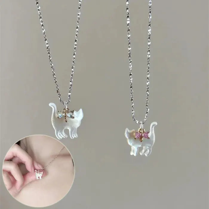 Cat Pendant Necklace worn on model, featuring pink-bow iridescent cat charm