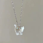 Cat Pendant Necklace with iridescent cat charm on a silver chain with small blue crystal bow.