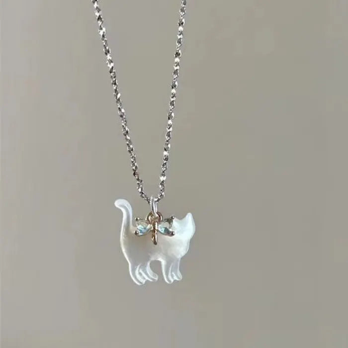 Cat Pendant Necklace with iridescent cat charm on a silver chain with small blue crystal bow.