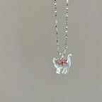 Cat Pendant Necklace featuring single iridescent cat pendant with pink gemstone bow
