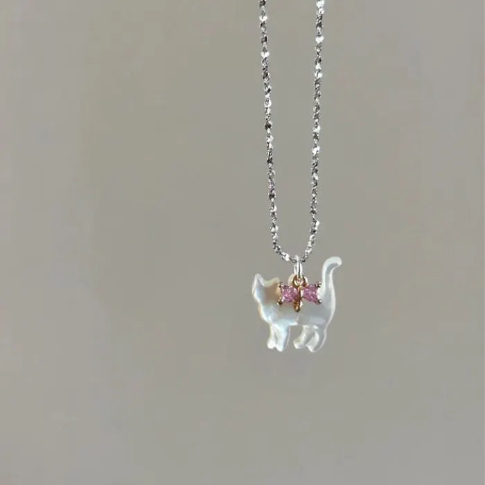 Cat Pendant Necklace featuring single iridescent cat pendant with pink gemstone bow