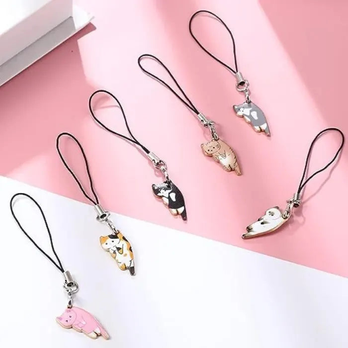 cat phone charm collection in mixed colors displayed on pink and white background