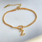 Gold bracelet with a 'Z' charm on a light gray background