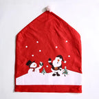 Santa hat shaped chair cover with snowman and Santa print in red and white on a flat surface.
