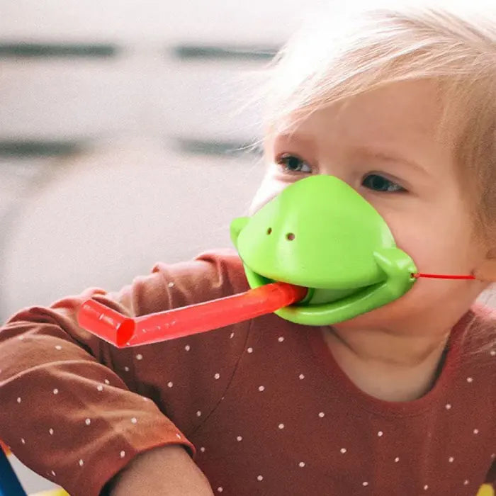 Young player demonstrating how to use the green lizard tongue catcher toy in action