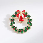 Christmas brooch shaped like a holiday wreath with red bell, bow, and green holly leaves