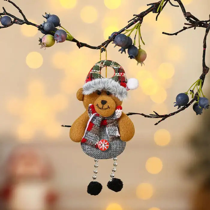 christmas decorations elderly bear plush ornament with scarf and hat hanging on branch with warm bokeh lighting