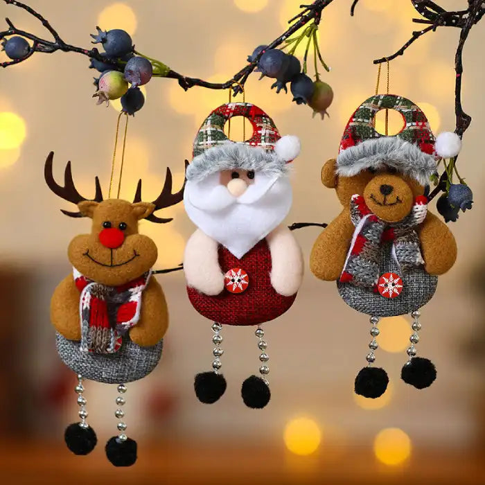 christmas decorations elderly trio of plush reindeer santa and bear ornaments displayed on branch with warm lights