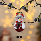 christmas decorations elderly snowman plush ornament with scarf and hat hanging on branch with soft lights