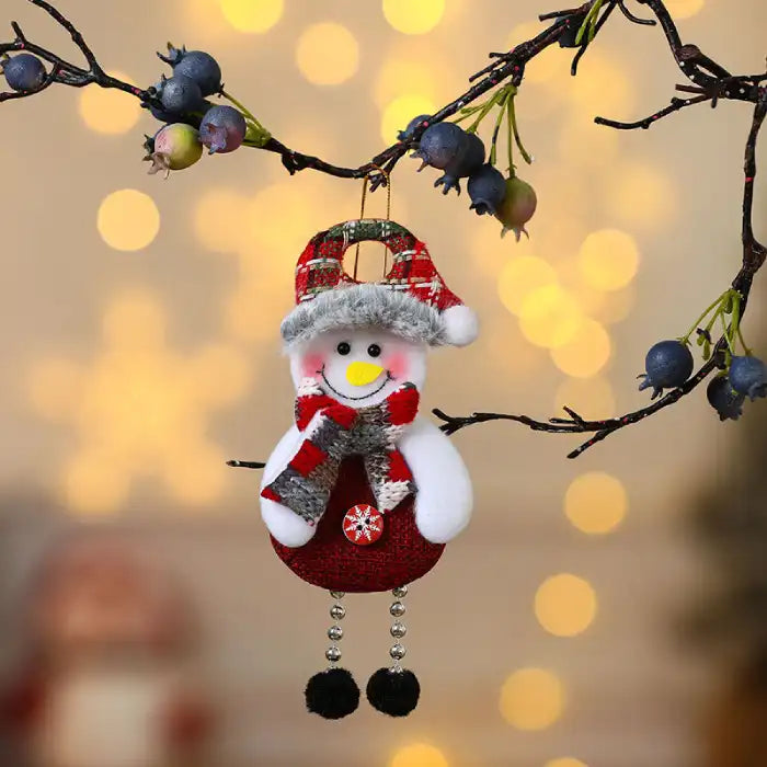 christmas decorations elderly snowman plush ornament with scarf and hat hanging on branch with soft lights
