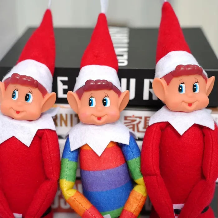 Close-up of three elf faces showing detailed features against black background