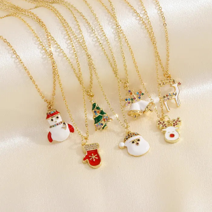 christmas jewelry assortment of gold necklaces with holiday-themed pendants
