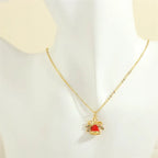 christmas jewelry gold necklace with red enamel bell and bow charm