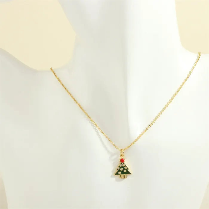 christmas jewelry gold necklace with green christmas tree charm and red top
