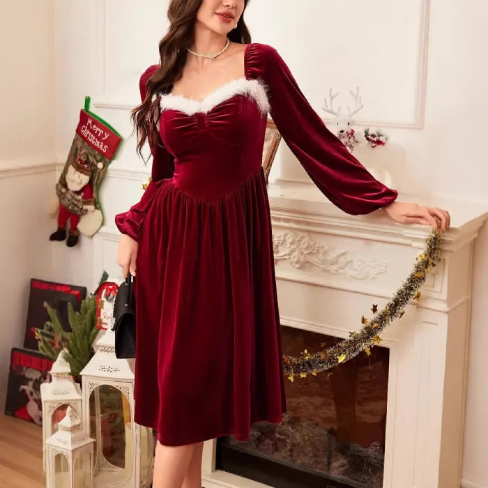 Christmas red velvet dress with white trim worn beside a decorated mantel and holiday décor.