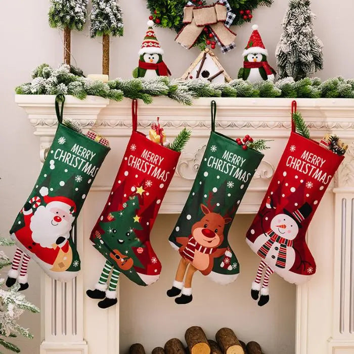 Four colorful Christmas stockings with festive characters hanging on a decorated mantel.