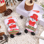 Christmas stockings with two snowman designs featuring red hats and bowties on snowy holiday background.