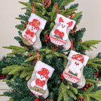 Christmas stockings hanging on Christmas tree featuring plush Santa, snowman, bear, and reindeer characters.