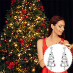 Christmas tree earrings with gemstones, styled in a festive holiday setting featuring a decorated tree.