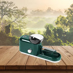 Cigarette Rolling Machine in dark green shown at an angle with natural forest background.