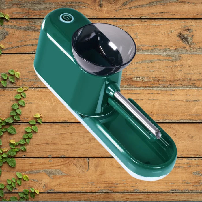 Cigarette Rolling Machine in glossy green shown from angled top view on rustic wood background.