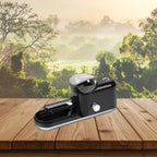 Cigarette Rolling Machine in black color placed on wooden surface with scenic forest view behind.