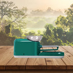Cigarette Rolling Machine in glossy green shown from side view on wooden surface outdoors.