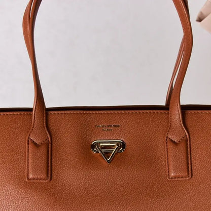 Close-up of brown leather tote bag, focusing on gold hardware, stitching details, and brand logo