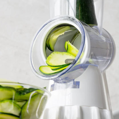 Close-up of cucumber slices being cut using a manual kitchen slicer for fresh salads.