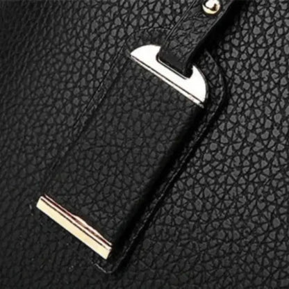 Close-up of black leather handbag strap with detailed stitching and gold-tone accents.