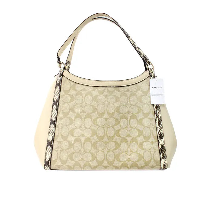 Back view of Coach monogram tote bag in beige, highlighting snake print details and smooth leather