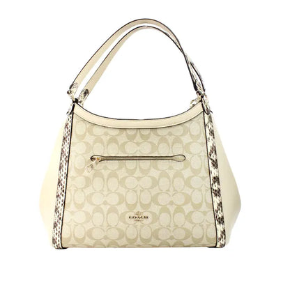 Coach snakeskin beige leather tote bag with monogram pattern and front zip pocket, featuring snake print accents.