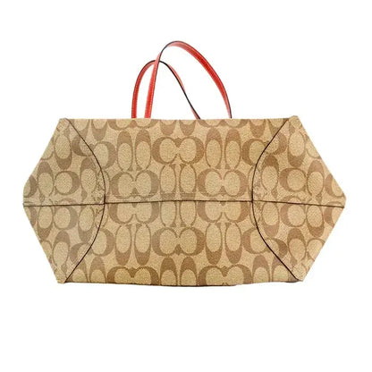 Bottom view of Coach tote bag showing detailed monogram print and sturdy base.