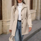 Coat Buttons beige buttoned coat styled with jeans and white top.