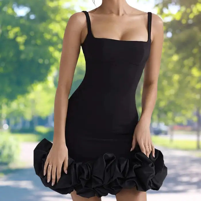 cocktail dress featuring fitted black silhouette with statement ruffle bottom styled against fresh green garden backdrop on summer day