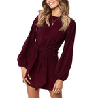  Cocktail dress in metallic gold wrap style with a v-neckline and waist tie for chic festive flair.
