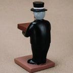 collector watch display showing the back view of a gentleman figurine in formal attire holding a watch platform.