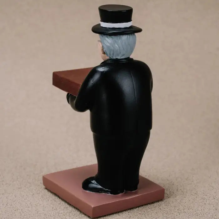 collector watch display showing the back view of a gentleman figurine in formal attire holding a watch platform.