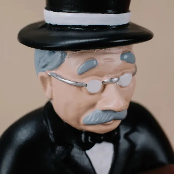 collector watch display close-up of the gentleman figurine's face, featuring glasses, mustache, and detailed painting.