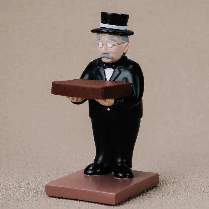 collector watch display figurine featuring a gentleman in formal attire holding a watch platform on a brown base.