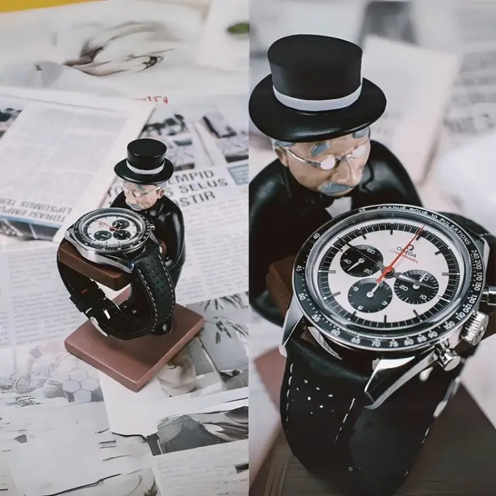 collector watch display figurine holding a luxury watch, placed on a newspaper background for a vintage aesthetic.