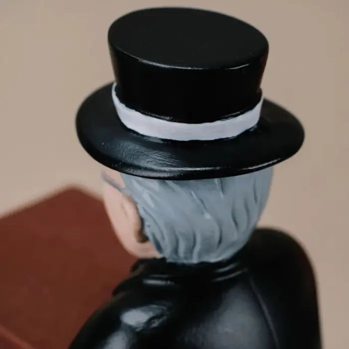 collector watch display close-up of the gentleman figurine's black top hat with a white band.